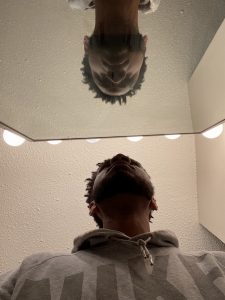 Man stares at reflection in mirror